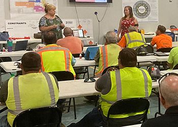 Workers in safety vests attending a training