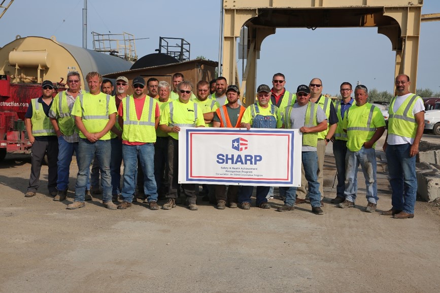 Opp Construction employees pose with SHARP renewal certificate