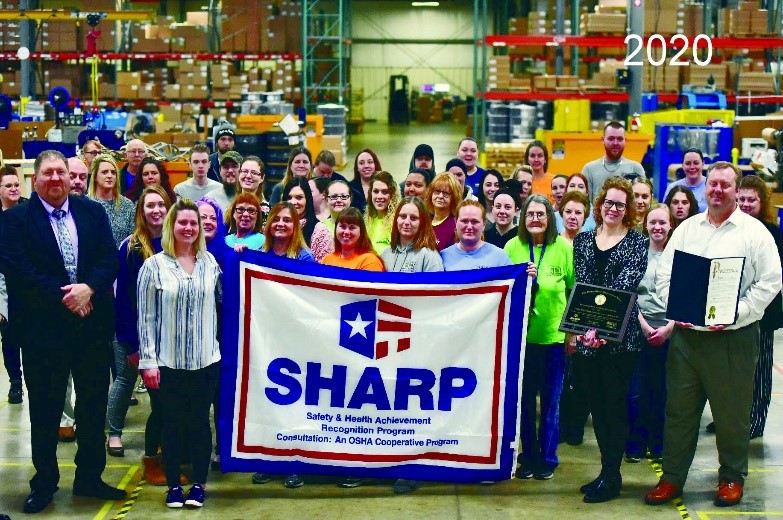 Staff pictured in 2020 with the SHARP flag