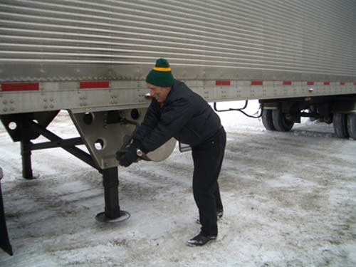 Figure 1 - Manual Cranking to lower the Trailer Landing Gear. Photo Credit: Women In Trucking, Inc.